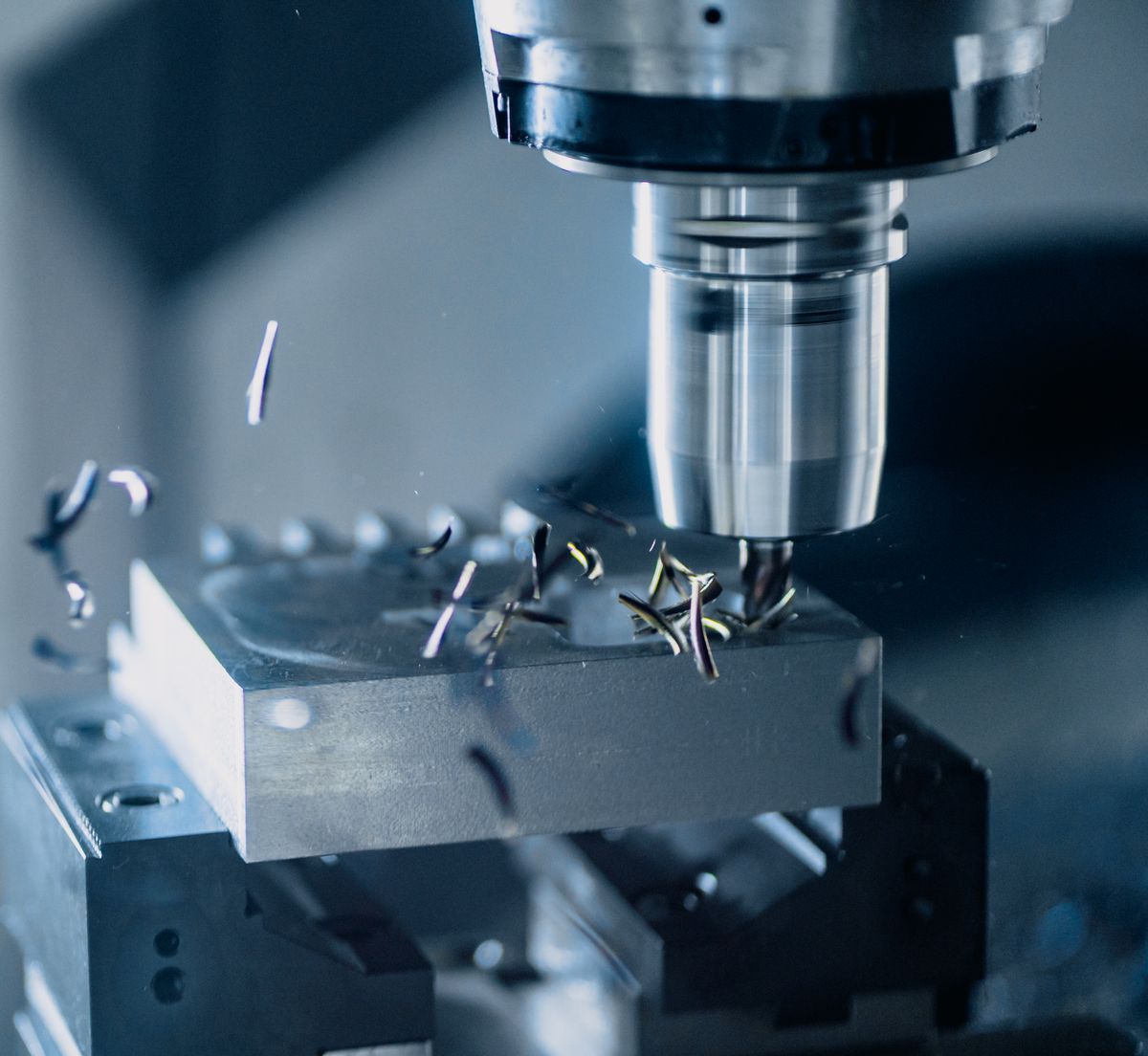 CNC milling machine cutting a metal component