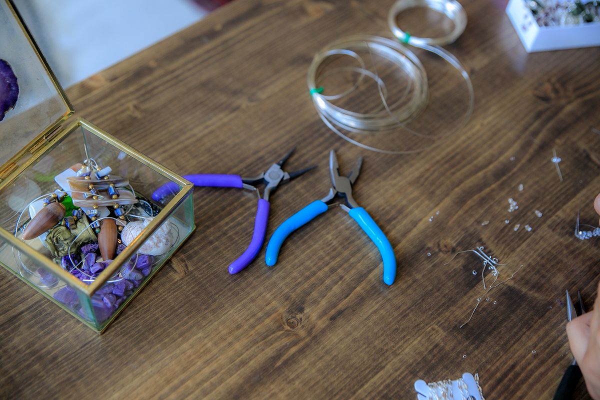 Jewelry components and tools laid out on a workbench